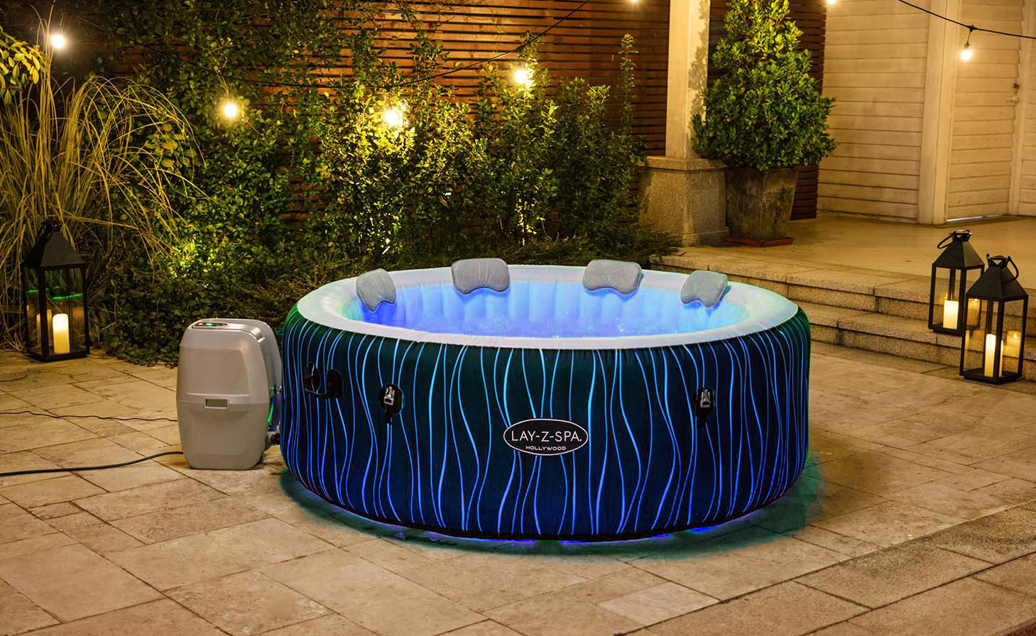 blue hot tub lit at night time in garden