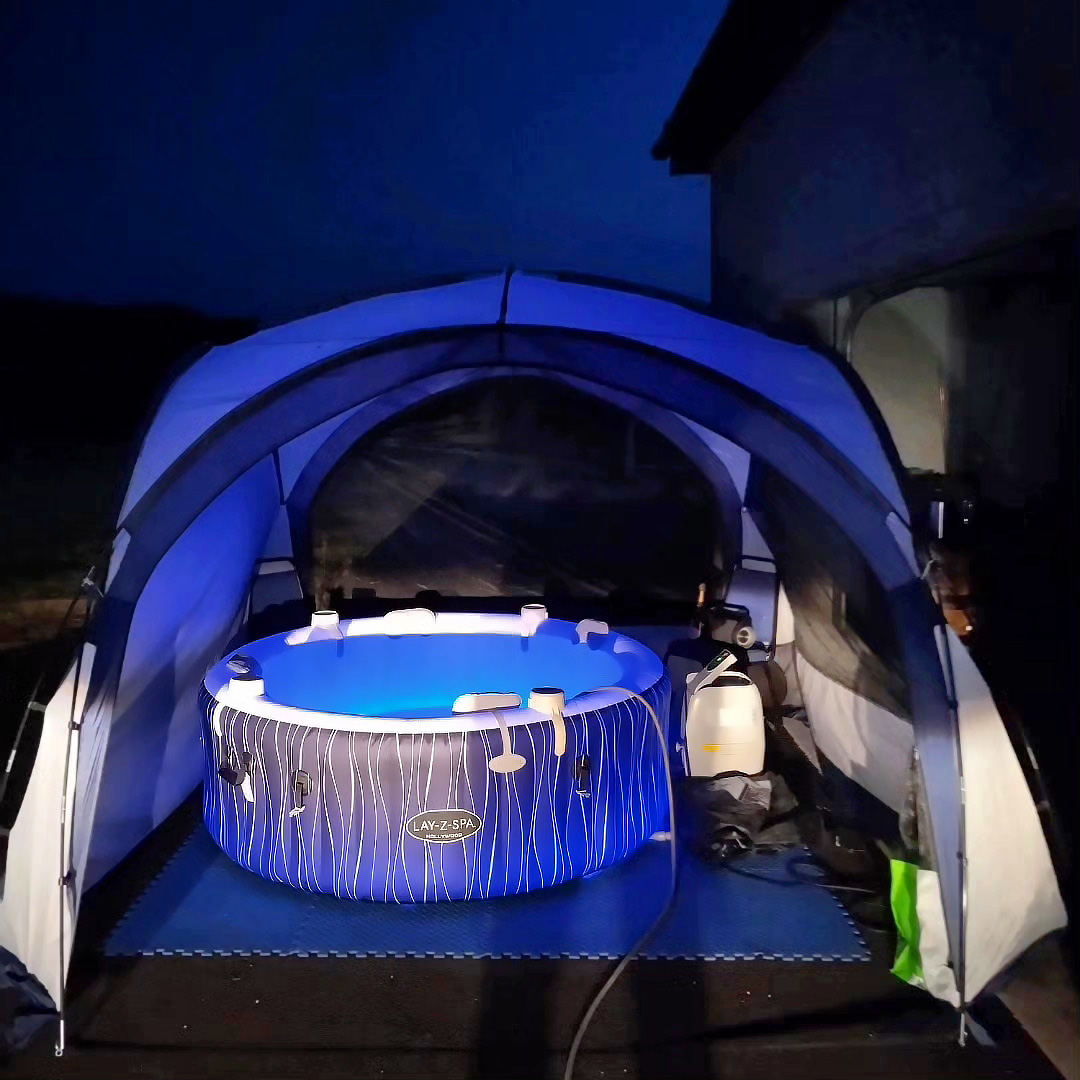 blue hot tub at night with tent